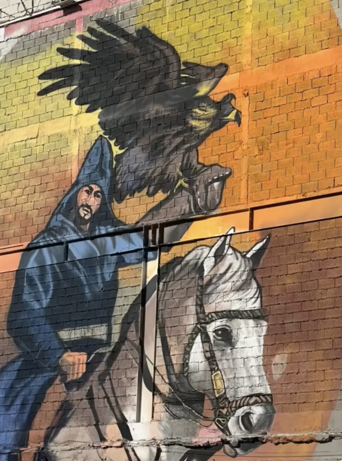 Mural of a rider beneath a flying eagle